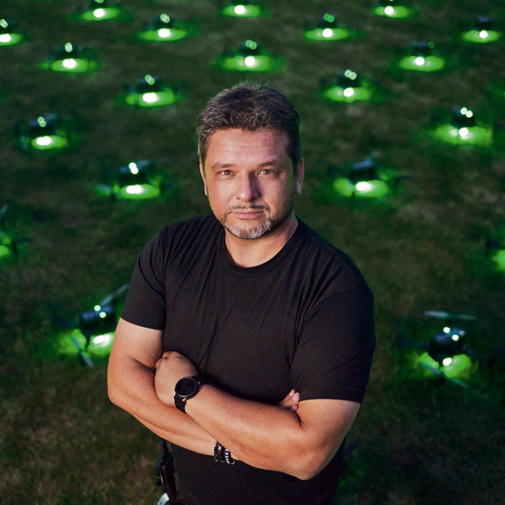 man in white dress shirt sitting on white couch using black Surface laptop